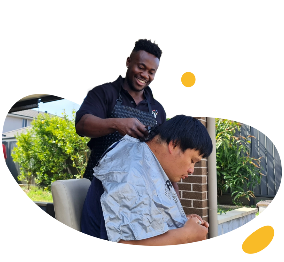 A man cutting the hair of a young boy.
