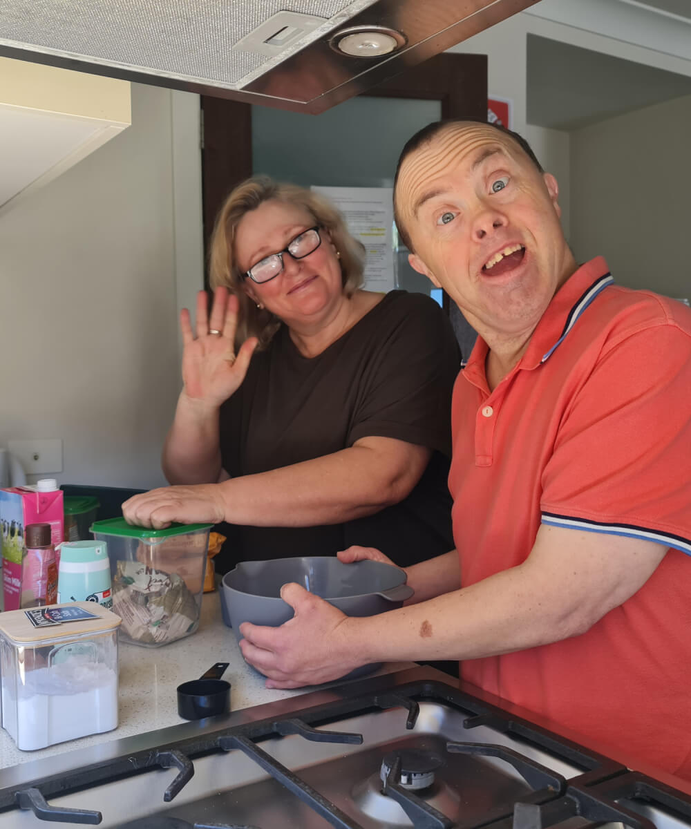 A man and a woman in a kitchen.